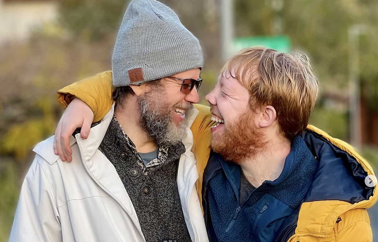 Andy & Jukie Doran looking at each other and laughing